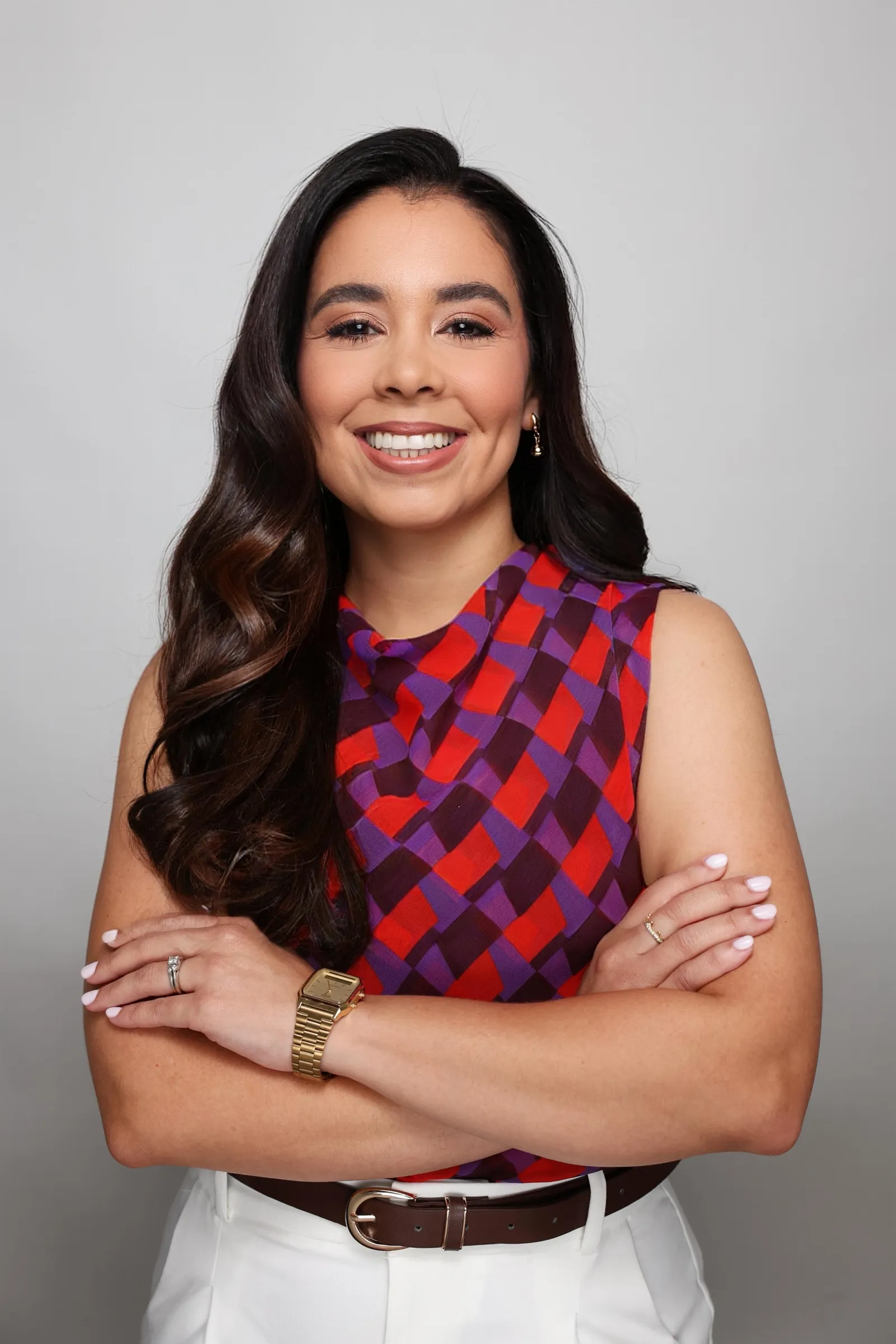 Mariene Ostolaza smiling with her arms crossed